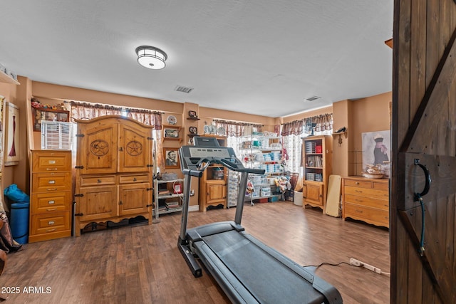 workout area featuring dark hardwood / wood-style flooring