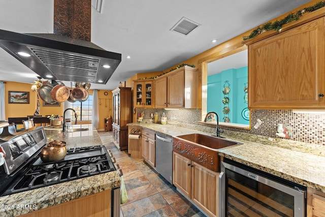 kitchen featuring sink, wine cooler, dishwasher, and island range hood