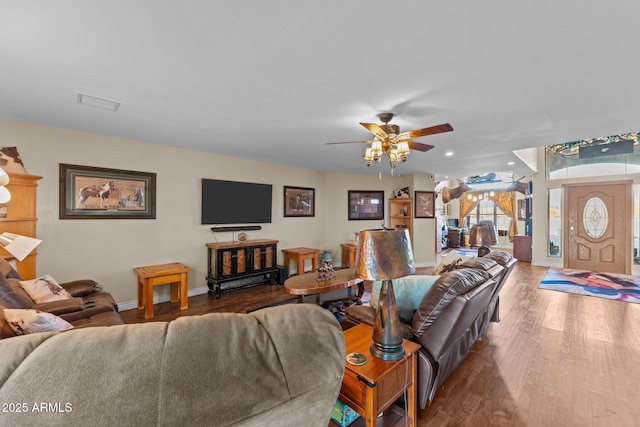 living room featuring ceiling fan and hardwood / wood-style floors