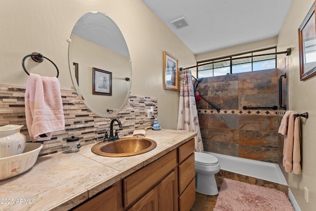 bathroom featuring toilet, backsplash, vaulted ceiling, vanity, and curtained shower