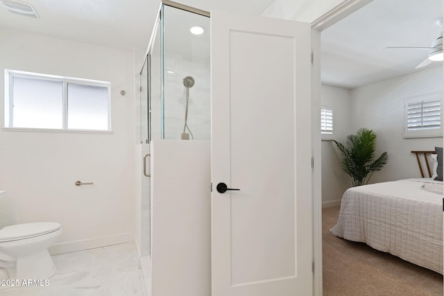 full bath with a ceiling fan, a wealth of natural light, connected bathroom, and a shower stall