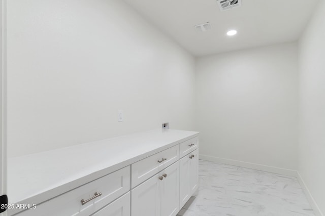 bathroom featuring marble finish floor, baseboards, visible vents, and recessed lighting