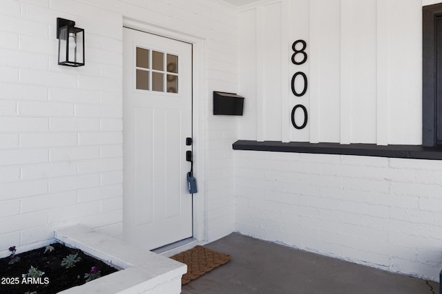 doorway to property featuring concrete block siding