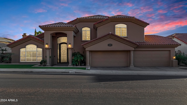 mediterranean / spanish-style home featuring a garage