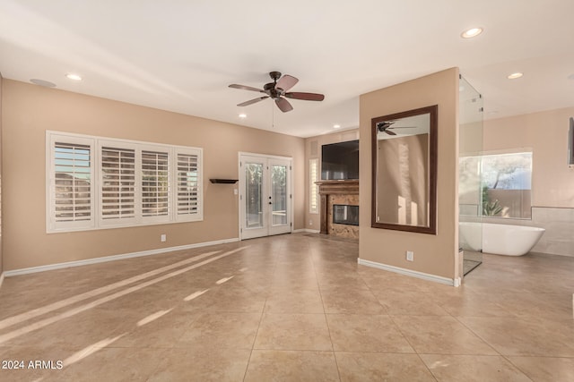 unfurnished living room with french doors, light tile patterned floors, and ceiling fan