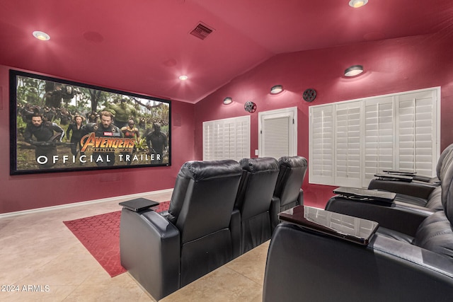 tiled cinema featuring vaulted ceiling