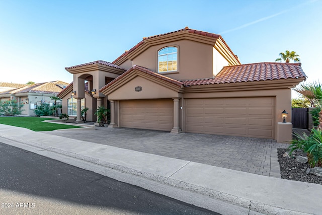 mediterranean / spanish-style house with a garage