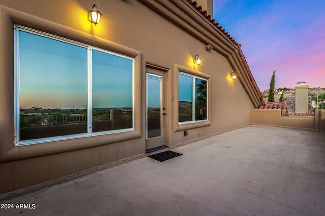 view of patio terrace at dusk