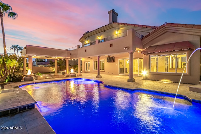 view of pool featuring pool water feature, a patio, and an outdoor hangout area