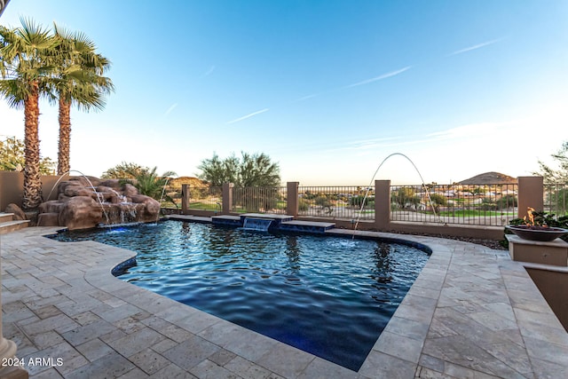 view of pool featuring pool water feature and a patio area