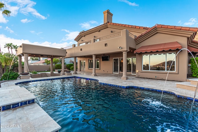 view of swimming pool featuring pool water feature and a patio area