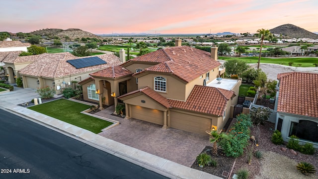 view of front of property featuring a mountain view and a garage