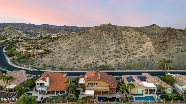 aerial view at dusk featuring a mountain view