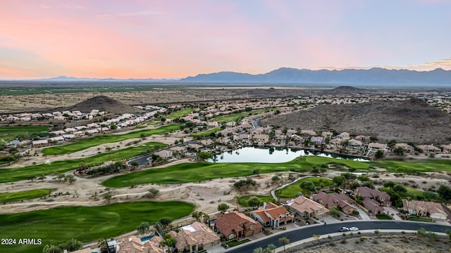 aerial view at dusk with a water and mountain view