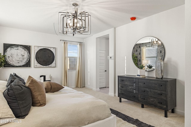 17738 W Onyx Ave, Waddell, AZ 85355 - bedroom with a chandelier, light colored carpet, and baseboards