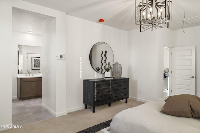 17738 W Onyx Ave, Waddell, AZ 85355 - bedroom with a chandelier, baseboards, a sink, ensuite bath, and light carpet
