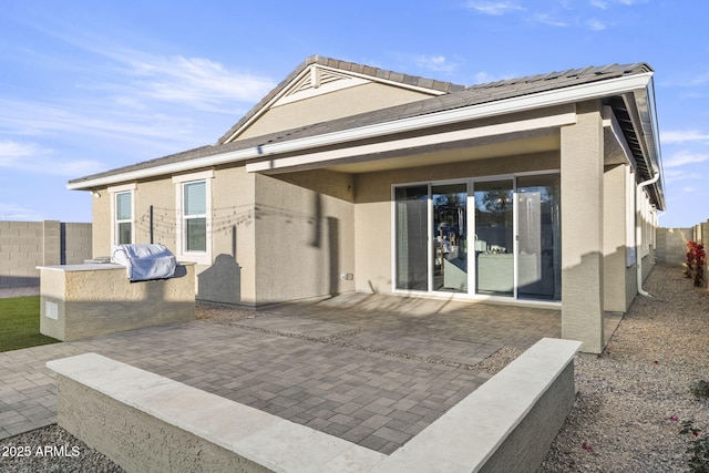 17738 W Onyx Ave, Waddell, AZ 85355 - back of house with a patio area, area for grilling, a fenced backyard, and stucco siding