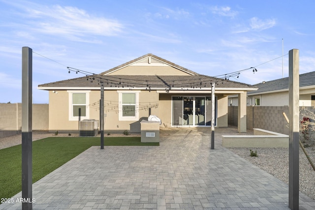 17738 W Onyx Ave, Waddell, AZ 85355 - rear view of house featuring stucco siding, a patio, and central air condition unit