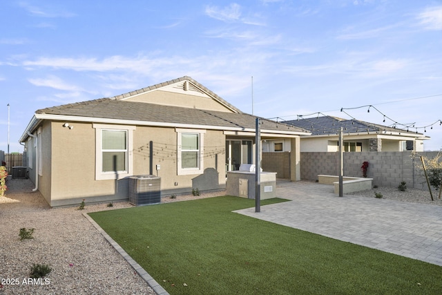17738 W Onyx Ave, Waddell, AZ 85355 - back of house featuring a patio, exterior kitchen, central AC, and stucco siding