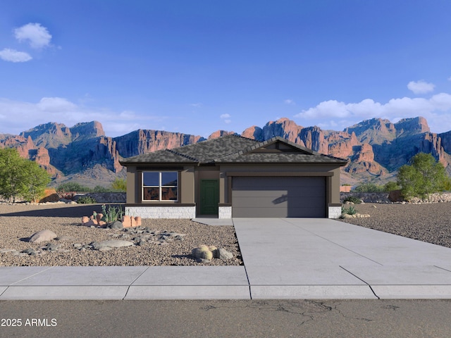 view of front of property with an attached garage, stone siding, concrete driveway, and stucco siding