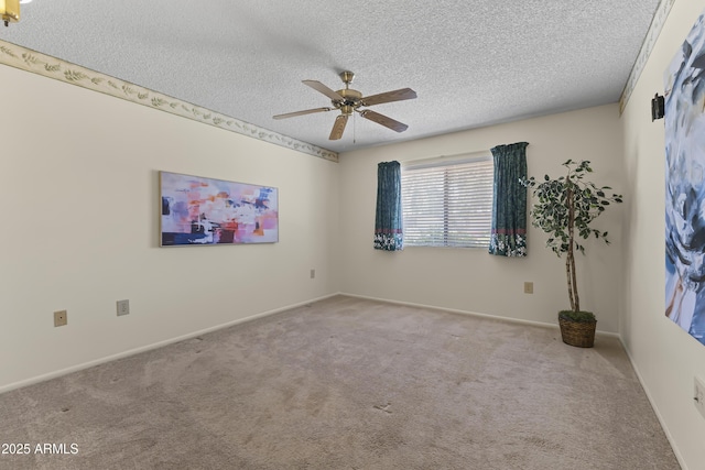 carpeted empty room featuring baseboards, ceiling fan, and a textured ceiling