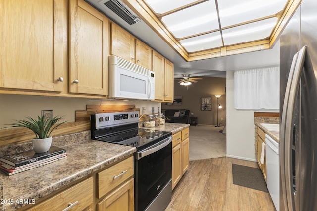kitchen with light wood finished floors, visible vents, appliances with stainless steel finishes, and light brown cabinets