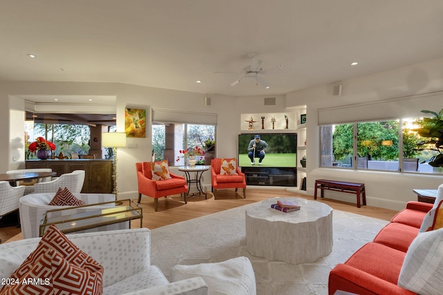 living room with ceiling fan, a healthy amount of sunlight, and light hardwood / wood-style floors