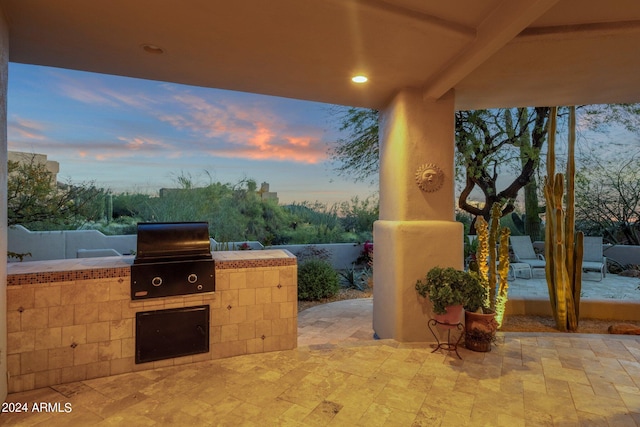 patio terrace at dusk with area for grilling and grilling area