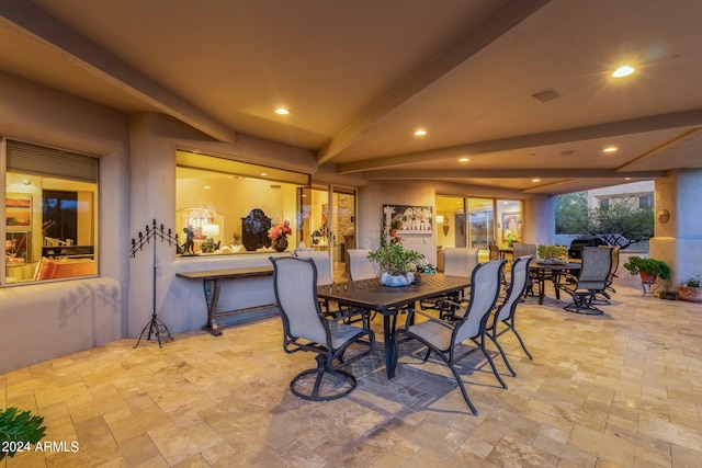 dining space featuring beam ceiling