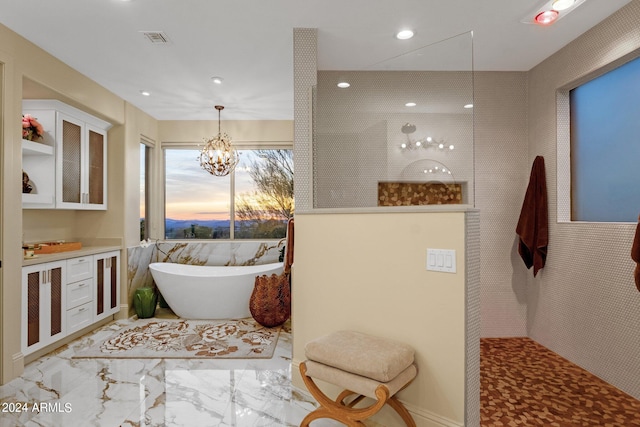 bathroom with tile walls, a notable chandelier, and independent shower and bath