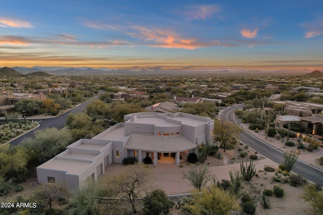 aerial view at dusk featuring a mountain view