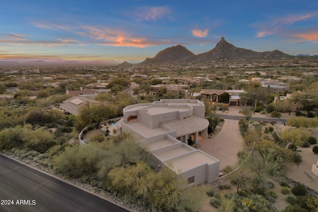 aerial view at dusk featuring a mountain view