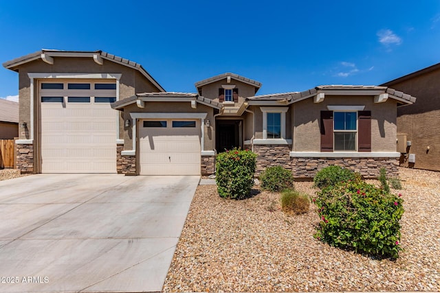 view of front facade featuring driveway, a tile roof, a garage, stone siding, and stucco siding
