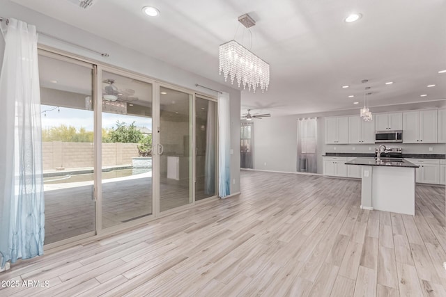 kitchen featuring a chandelier, dark countertops, appliances with stainless steel finishes, and recessed lighting