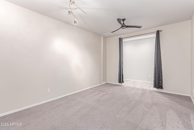 empty room with baseboards, carpet, and a ceiling fan