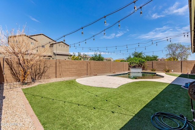 view of yard with a patio, a fenced in pool, and a fenced backyard