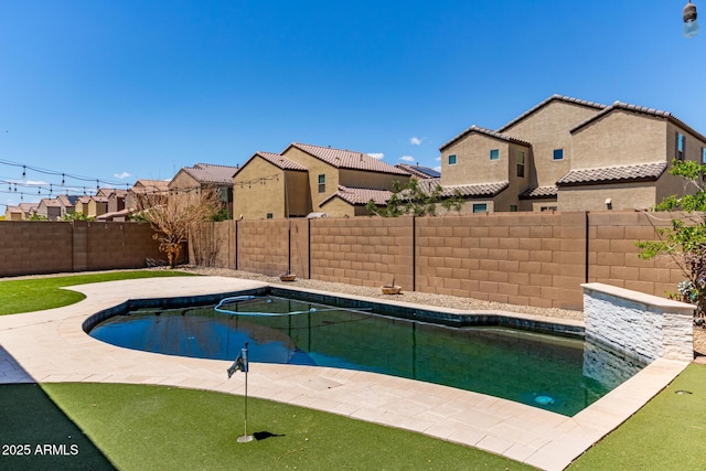 view of pool featuring a fenced backyard, a fenced in pool, a patio area, and a residential view