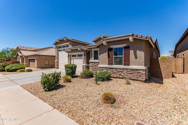 craftsman-style house featuring driveway, a garage, fence, stone siding, and stucco siding