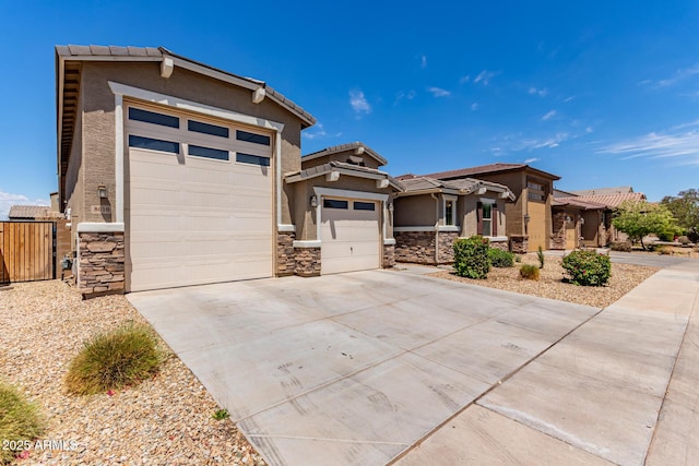 prairie-style house featuring concrete driveway, stone siding, and stucco siding