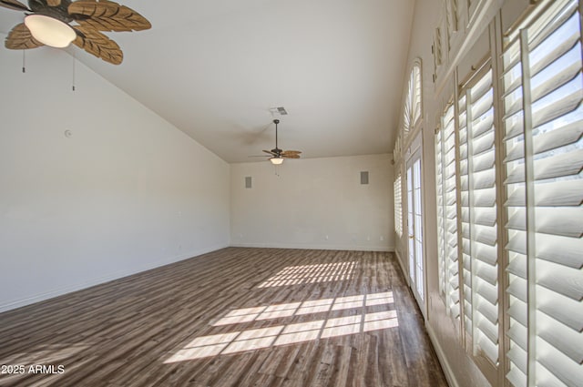 empty room featuring wood finished floors, visible vents, a ceiling fan, baseboards, and high vaulted ceiling