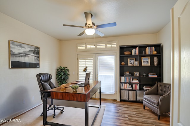 office space featuring wood finished floors, baseboards, and ceiling fan