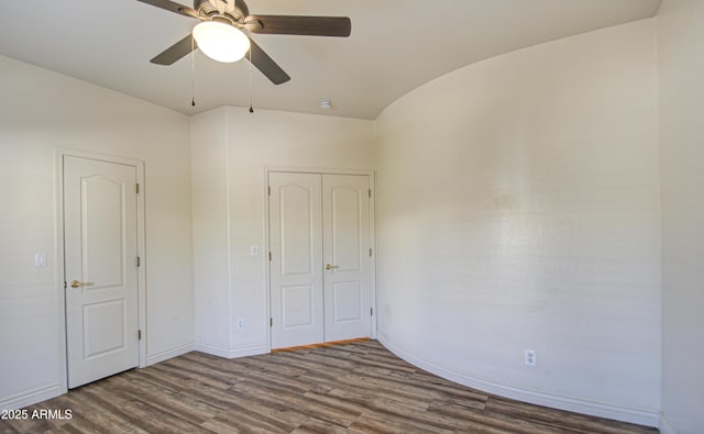 unfurnished bedroom featuring ceiling fan, baseboards, and wood finished floors