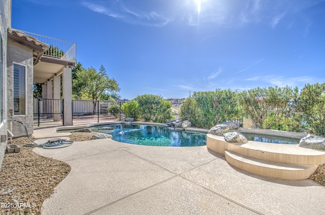 view of swimming pool with a patio area, a fenced in pool, and fence