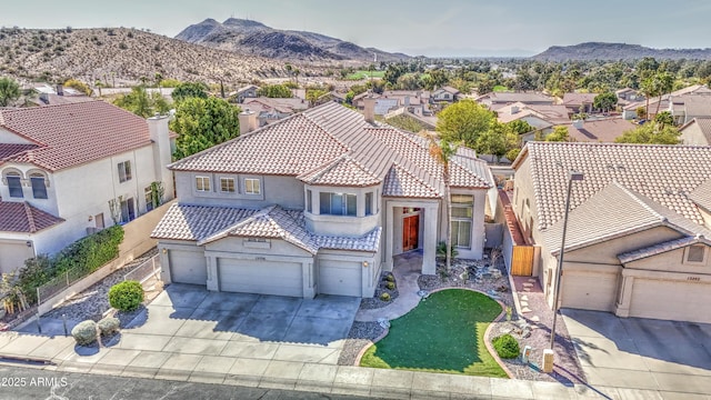 view of front facade with a residential view, stucco siding, concrete driveway, and fence