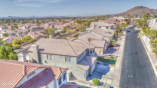 birds eye view of property with a mountain view and a residential view