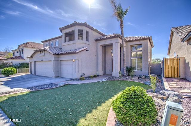 mediterranean / spanish-style home featuring a gate, fence, stucco siding, concrete driveway, and a tile roof