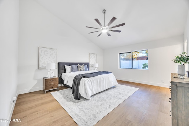 bedroom with light wood-style floors, baseboards, a ceiling fan, and high vaulted ceiling
