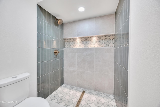 full bathroom with toilet and tiled shower