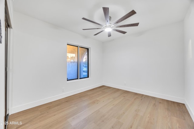 unfurnished room with ceiling fan, baseboards, and light wood finished floors