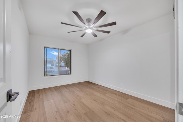 unfurnished room featuring a ceiling fan, baseboards, and light wood-style flooring